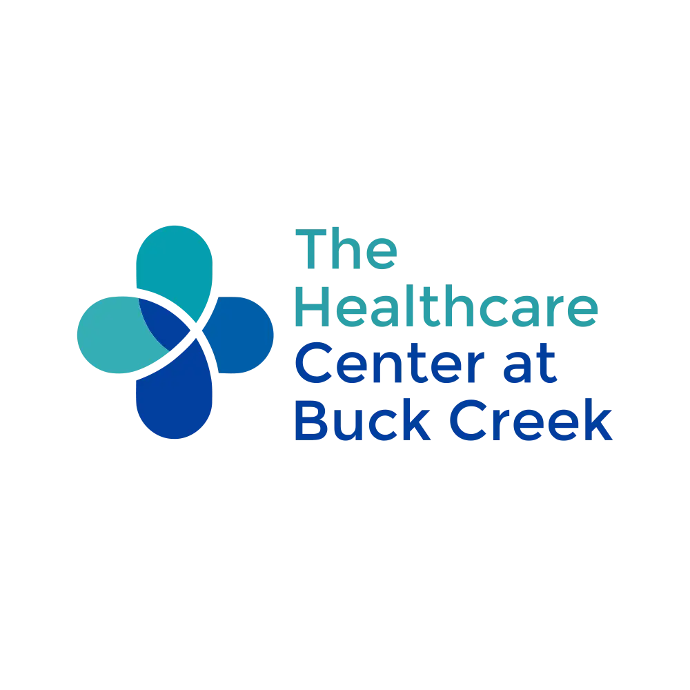 Logo for The Healthcare Center at Buck Creek, featuring a blue and teal abstract cross symbol next to the facility name in blue and teal text.